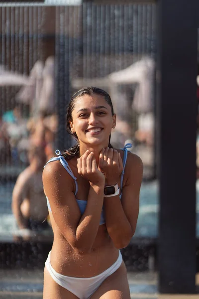 Menina bonita em roupa de banho Chuveiros sob a água na praia Resort. — Fotografia de Stock