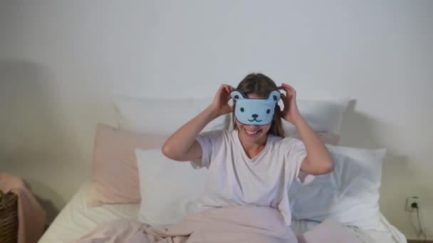 Happy somnolent jeune femme adulte se réveillant couché dans un lit blanc — Video