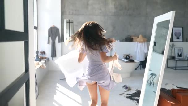 Beautiful girl trying dress in room — Stock Video