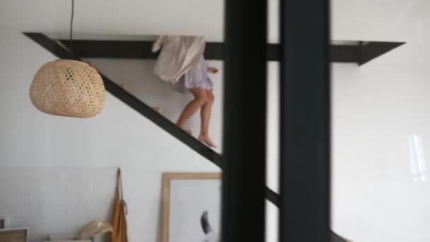 Young beautiful woman in lingerie walks the steps at home — Stock Video