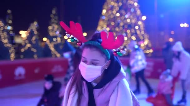 Menschen genießen Schlittschuhlaufen auf der Straße rund um den Weihnachtsbaum in Eisbahn. — Stockvideo