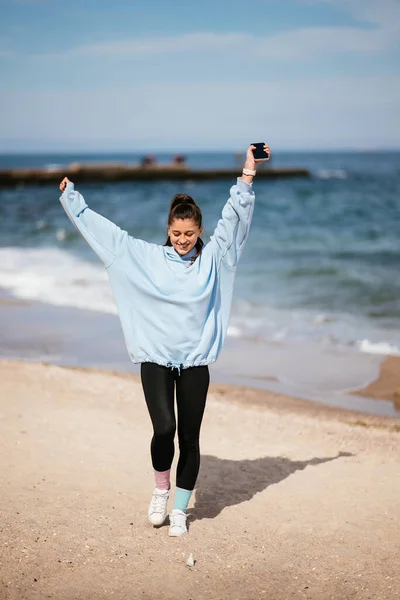 Belle femme dans une plage publique après une promenade avec un look sportif — Photo