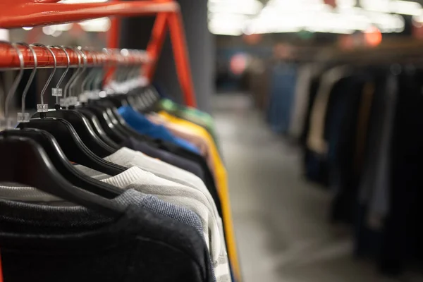 Stylish clothes on a hanger in a store. New collection of coats. — Stock Photo, Image