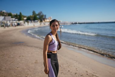 Spor antrenmanından sonra halk plajında güzel bir kadın.