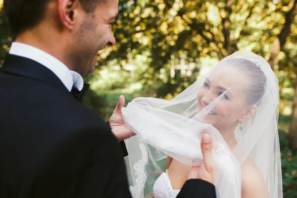 De bruidegom liften de sluier van de bruid — Stockfoto