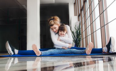 Anne ve kızı hugs ve spor streç