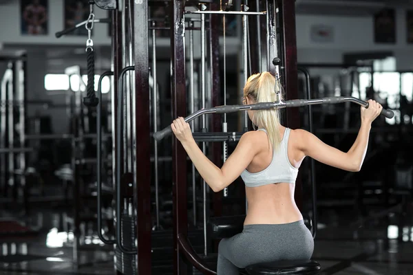 Mooi atletische meisje houdingen in de sportschool — Stockfoto