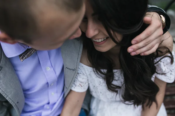 Young European couple cuddling on a park bench — Stock Photo, Image