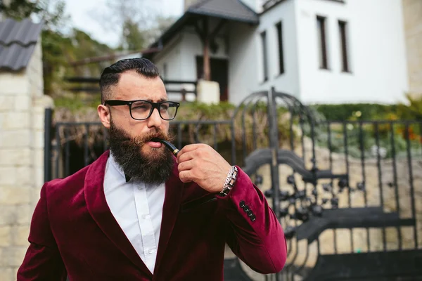 Rich man in a jacket near his house — Stock Photo, Image