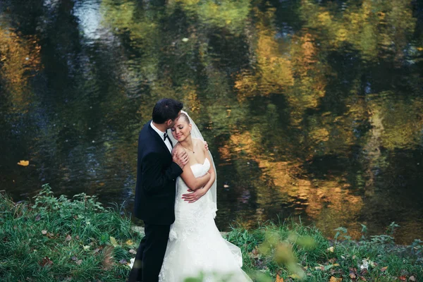 Bruden och brudgummen poserar tillsammans på kamera — Stockfoto