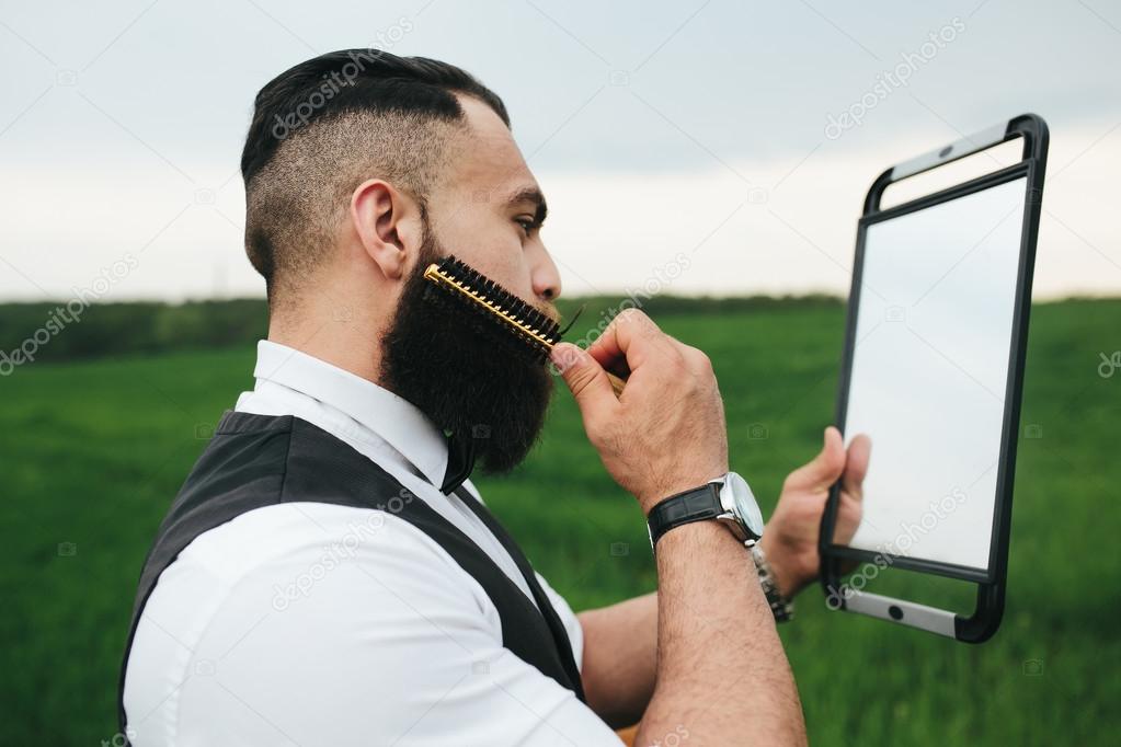 bearded man preparing to shave