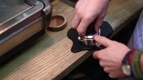 Barista presses the coffee for espresso — Stock Video