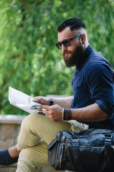 Bearded man looking at a map — Stock Photo, Image