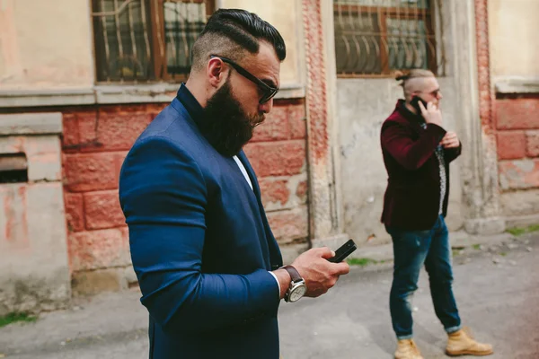 Bearded businessman looking at phone — Stock Photo, Image