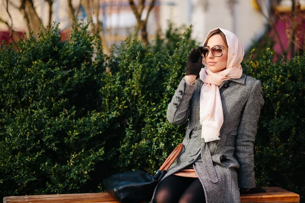 Ragazza seduta su una panchina nel parco — Foto Stock