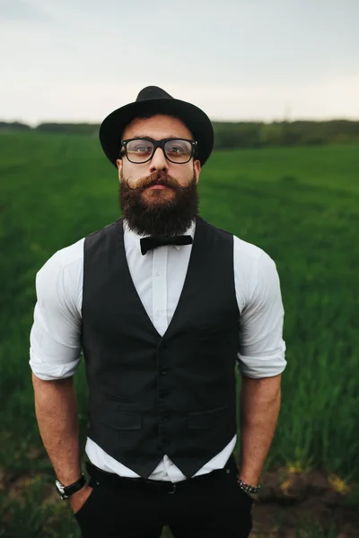 Man with a beard, thinking in the field — Stock Photo, Image