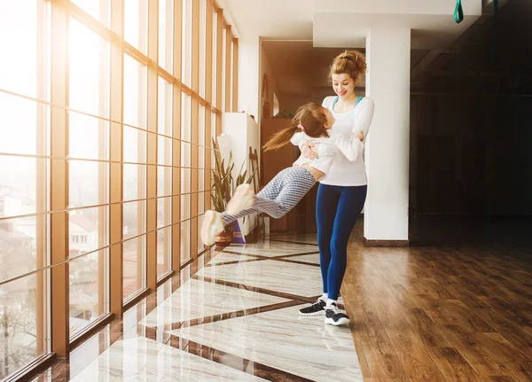 Madre tuerce a su hija en el gimnasio — Foto de Stock