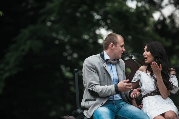 Young European couple cuddling on a park bench — Stock Photo, Image