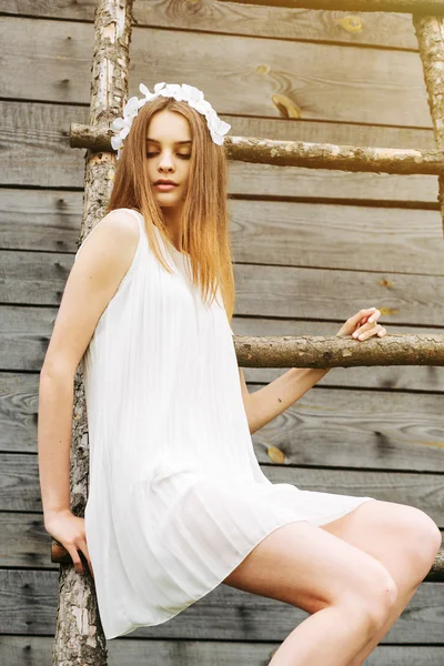 Girl climbing ladder into tree house — Stock Photo, Image