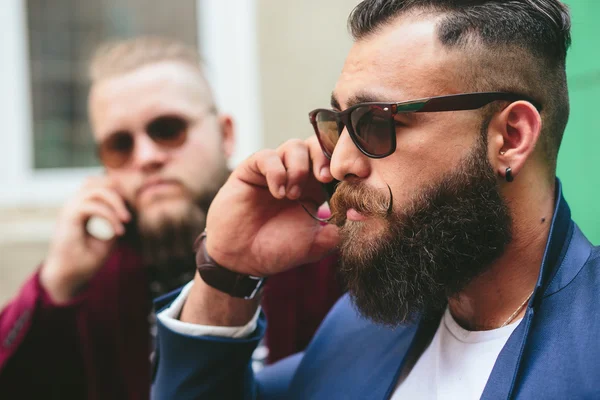 Dos hombres de negocios barbudos mirando el teléfono —  Fotos de Stock
