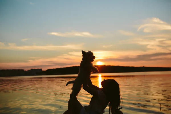 Girl and dog on the lake — Stock Photo, Image