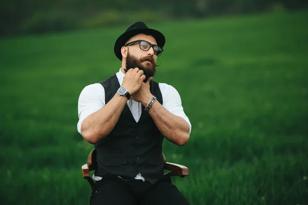 Man with a beard, thinking in the field — Stock Photo, Image