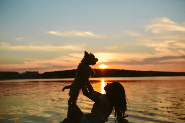 Fille et chien sur le lac — Photo