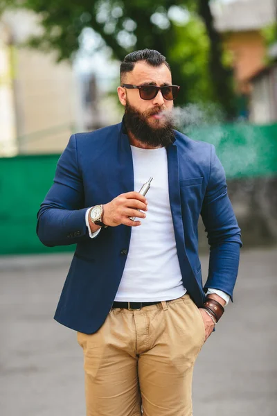 Homem com barba fuma cigarro eletrônico — Fotografia de Stock