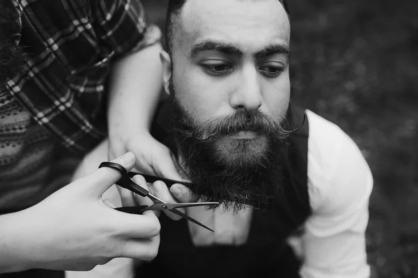 Barbiere radere un uomo barbuto — Foto Stock