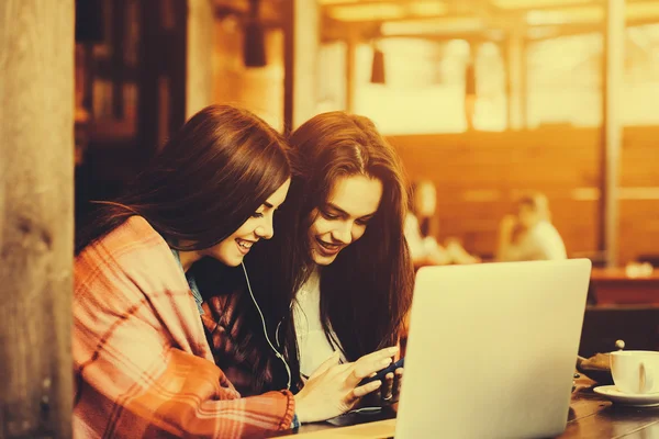 Two girls watching something in laptop — Stock Photo, Image