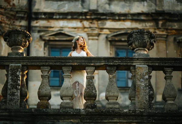 Beautiful woman on a balcony — Stock Photo, Image