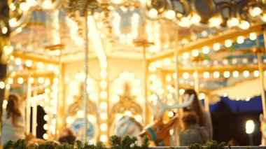 Gece parlayan atlıkarınca, siluet fotoğrafçıları Bokehful sahnesini yakalıyor, sıcak altın ışıklar, bulanık atlar, hareket,