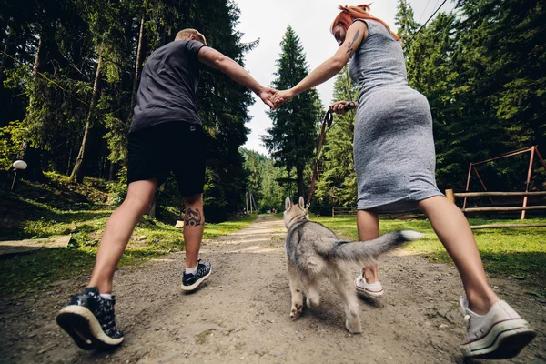 Par körs på väg i naturen med hund — Stockfoto