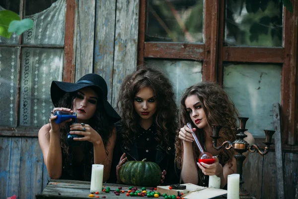 Three vintage witches perform magic ritual — Stock Photo, Image