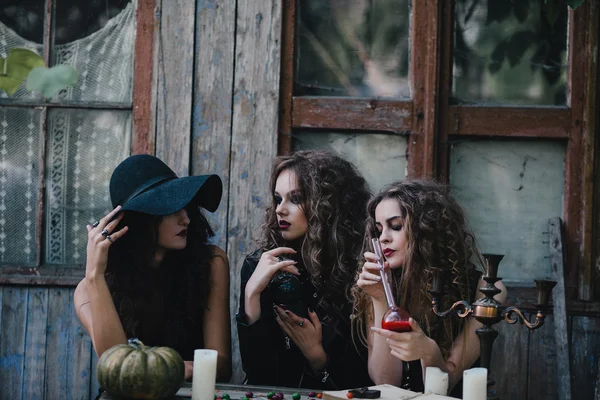 Three vintage witches perform magic ritual — Stock Photo, Image