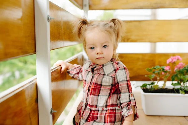 Little girl playing on the balcony — Stock Photo, Image