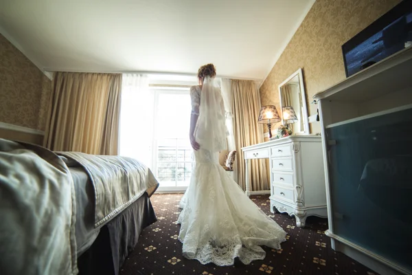 Bride looking through the window — Stock Photo, Image