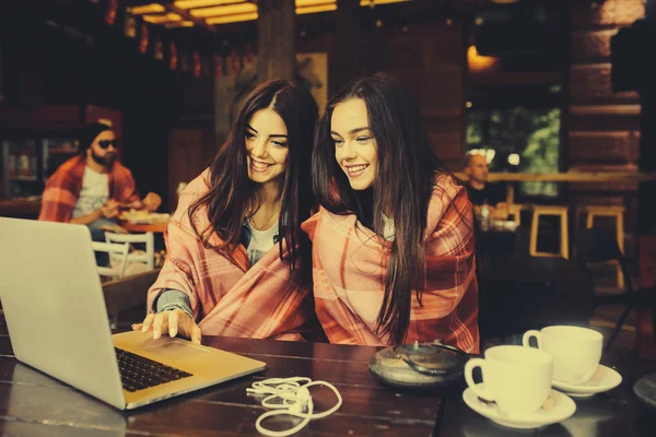 Two girls watching something in laptop — Stock Photo, Image