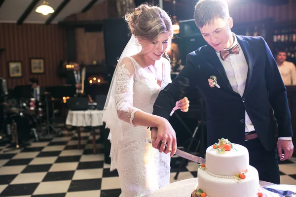 bride and groom cut cake