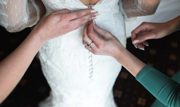 Bride putting on her dress — Stock Photo, Image