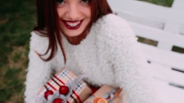 Beautiful girl holding gifts — Stock Video