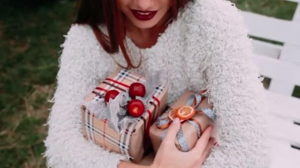 Beautiful girl holding gifts — Stock Video