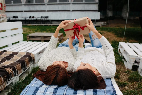Las niñas mienten y desempaca un regalo — Foto de Stock
