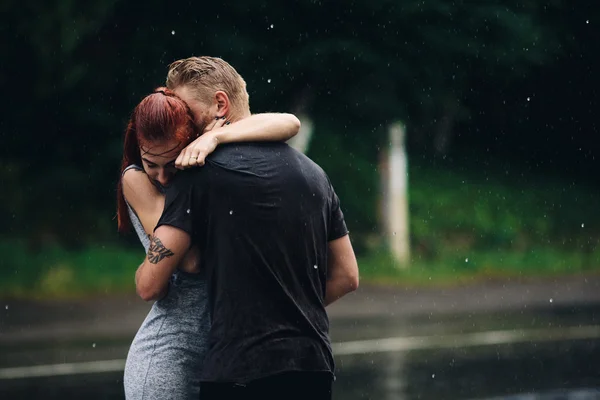 Beautiful couple hugging in the rain — Stock Photo, Image