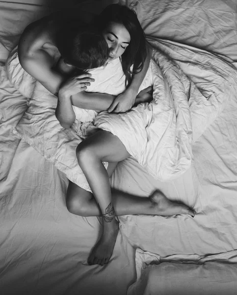 Young couple in bed together — Stock Photo, Image