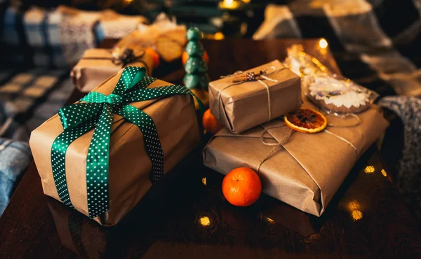 Gifts lie on wooden table — Stock Photo, Image