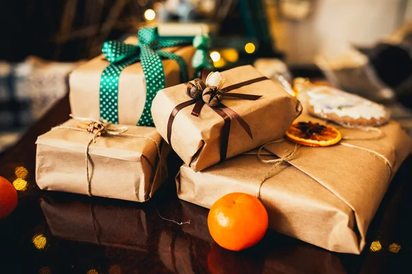 Gifts lie on wooden table — Stock Photo, Image