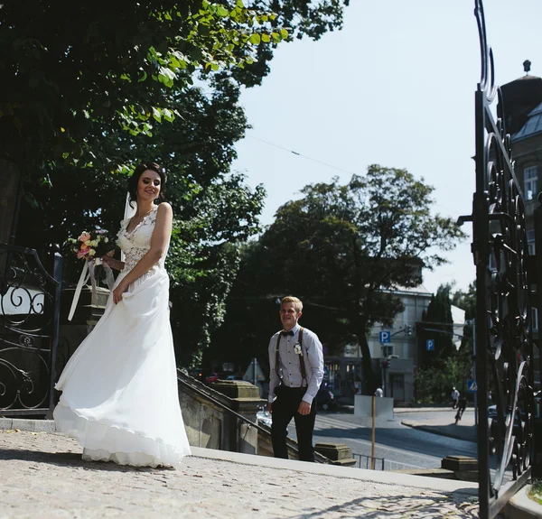 Bruden och brudgummen poserar på gatorna — Stockfoto
