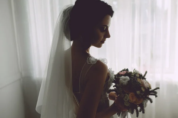 Bride posing in a large window — Stock Photo, Image