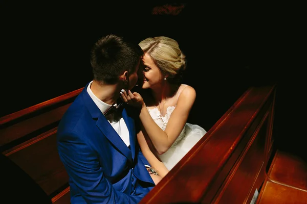 Bride and groom illuminated by light — Stock Photo, Image